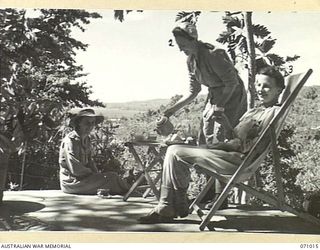 HELDSBACH MISSION, FINSCHHAFEN AREA, NEW GUINEA. 1944-03-13. SISTERS OF THE AUSTRALIAN ARMY NURSING SERVICE, HAVING MORNING TEA AT THEIR MESS OVERLOOKING FINSCHHAFEN HARBOUR. SITUATED HIGH ABOVE ..