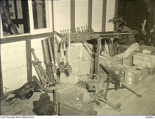 NEW GEORGIA, SOLOMON ISLANDS. 1943-03. PART OF THE COASTWATCHERS ARSENAL OF UNITED STATES AND CAPTURED JAPANESE WEAPONS HELD BY CAPTAIN D.G. KENNEDY, BRITISH SOLOMON ISLANDS PROTECTORATE DEFENCE ..