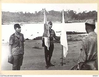 MIVO RIVER AREA, BOUGAINVILLE. 1945-08-18. FIRST CONTACT BETWEEN THE JAPANESE SURRENDER ENVOY AND AUSTRALIAN TROOPS ON BOUGAINVILLE. MAJOR OTSU AND SUPERIOR PRIVATE TAKESHITA WHO IS CARRYING THE ..