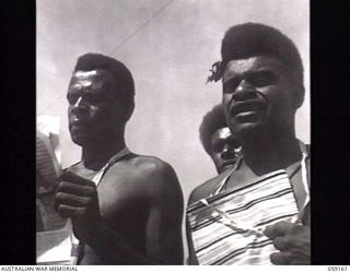 KILA, NEW GUINEA. 1943-10-24. NATIVE LABOURERS WHO ATTENDED THE PARADE FOR PP1 MAJOR GENERAL B. M. MORRIS DSO, GENERAL OFFICER COMMANDING, AUSTRALIAN AND NEW GUINEA ADMINISTRATIVE UNIT WITH THEIR ..