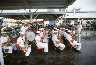 A Navy band plays at a welcoming ceremony for crew members of the combat stores ship USS NIAGARA FALLS (AFS 3) at Naval Station Guam