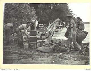 WAITAVALO AREA, WIDE BAY, NEW BRITAIN. 1945-03-16. PERSONNEL OF THE 6TH FIELD AMBULANCE, ARMY MEDICAL CORPS AMONG UNLOADED STORES AT THE BEACHHEAD