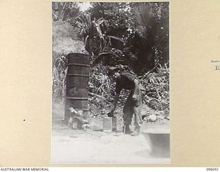 WIRUI BEACH, WEWAK AREA, NEW GUINEA. 1945-08-25. PRIVATE J.B. BUTLER, THE INCINERATOR MAN, 2/11 INFANTRY BATTALION