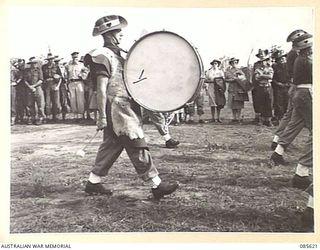 HERBERTON RACECOURSE, WONDECLA, ATHERTON TABLELAND, QLD. 1945-01-19. PRIVATE C W OSBORNE, BASS DRUMMER, (1), 2/13 INFANTRY BATTALION PARTICIPATING IN THE 9 DIVISION GYMKHANA