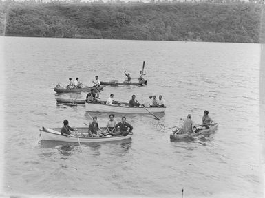 [Pacific Island men in dinghies and canoes]