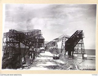 NAURU ISLAND, 1945-09-16. THE STEEL CANTILEVER LOADING WHARF OF THE BRITISH PHOSPHATE COMMISSION WHICH WAS WRECKED BY A GERMAN RAIDER IN THE OPENING STAGES OF THE WAR