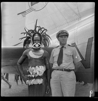 Local man in traditional dress with Captain W Forgan-Smith, Qantas Empire Airways, Kerowagi, Simbu, Papua New Guinea