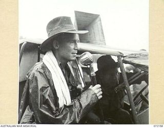 LAKONA, NEW GUINEA. 1944-04-08. NX123685 LIEUTENANT C.S. PEEBLES, OF 30TH INFANTRY BATTALION, 8TH INFANTRY BRIGADE, ACTING AS COMMENTATOR AND ANNOUNCER AT THE SWIMMING CARNIVAL HELD ON LAKONA ..