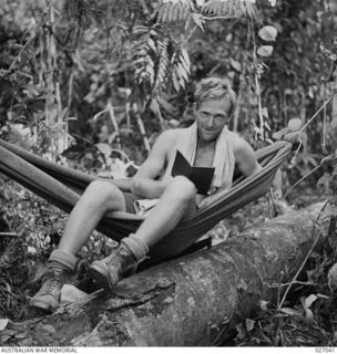 PAPUA, NEW GUINEA. 1942-10. JOHN BROMWICH, AUSTRALIAN DAVIS CUP TENNIS STAR PLAYER, IS NOW CORPORAL J. BROMWICH, OF AIR SUPPORT CONTROL SIGNALS ATTACHED 25TH AUSTRALIAN INFANTRY BRIGADE, HERE HE IS ..