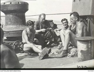 AT SEA EN ROUTE TO AITAPE, NORTH EAST NEW GUINEA. 1944-04-20. PLAYING CARDS HELPED WHILE AWAY THE LONG HOURS AT SEA, WHILE RAAF ENGINEERS WERE ON THEIR WAY TO AITAPE WHERE THEY LANDED JUST BEHIND ..