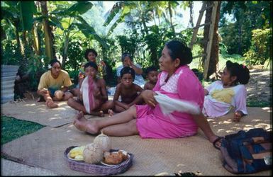 Group sitting on mats under trees