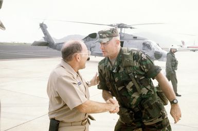 RADM William Retz, commander, Naval Base, Pearl Harbor, welcomes BGEN Robert Akers, commander, Joint Task Force Garden Isle, upon Akers' arrival on the island of Kauai. The task force has been organized to deliver supplies to the residents of the area in the aftermath of Hurricane Iniki