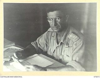 SOUTH ALEXISHAFEN, NEW GUINEA. 1944-08-08. QX6264 LIEUTENANT-COLONEL W.E.E. LANGFORD, CO, 111TH CASUALTY CLEARING STATION AT WORK IN HIS OFFICE