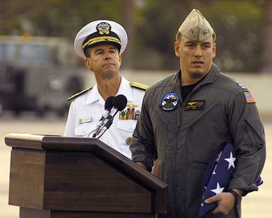 Admiral (ADM) Thomas Fargo, USN, Commander Pacific Fleet, watches as Lieutenant (LT) Shane Osborn, USN, Commander of the USN EP-3 Aries II aircraft involved in the March 31st accident with a Chinese F-8 aircraft, prepares to address the crowd, as he is welcomed at Hickam AFB, Hawaii. The crew arrived at Hickam AFB, HI from Anderson AB, Guam on board an USAF C-17 Globemaster III aircraft, as part of Operation VALIANT RETURN. The EP-3 crew members were detained in China for 17 days prior to being released