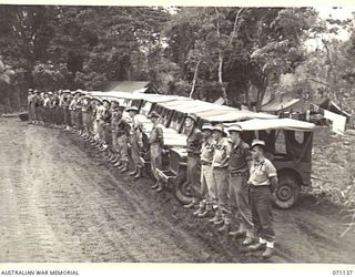 KILIGIA, NEW GUINEA, 1944-03-12. DRIVERS OF THE 5TH DIVISION TRANSPORT SECTION LINES IN FRONT OF THEIR JEEPS DURING THE MORNING PARADE. IDENTIFIED PERSONNEL ARE: QX45493 DRIVER J.T. O'SHEA (1); ..