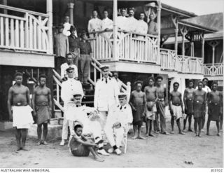 COLONEL WILLIAM HOLMES AND STAFF AT GOVERNMENT HOUSE, NAMANULA, RABAUL, 1914. STANDING, LEFT TO RIGHT: LIEUTENANT F.G. CRESSWELL RAN, CAPTAIN R.J.A. TRAVERS. SITTING: COLONEL WILLIAM HOLMES AND ..