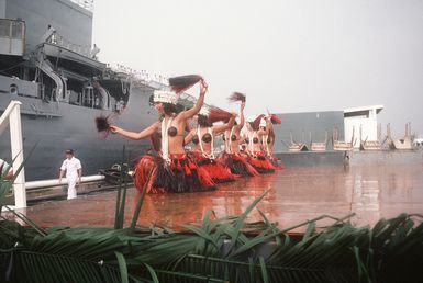 Dancers entertain visitors and crewmen of the combat stores ship USS NIAGARA FALLS (AFS 3) upon the ship's arrival at Naval Station Guam