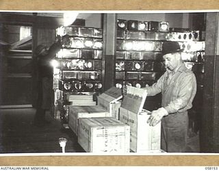 KENSINGTON, VIC. 1943-10-23. WORKMEN PACKING TINS OF FLOUR INTO BOXES AT THE MILLS OF MESSRS KIMPTON & SONS FOR DESPATCH TO THE TROOPS IN NEW GUINEA. EACH CASE CONTAINS TWO TINS, GROSS WEIGHT 66LBS