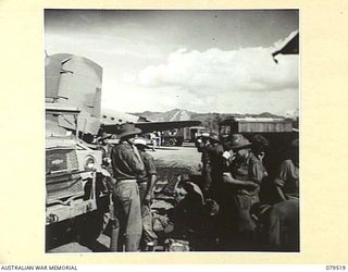 LAE, NEW GUINEA. 1943-11. PATIENTS WAITING AT THE STRIP A.D.S (AIRSTRIP ADVANCED DRESSING STATION) OF THE 10TH FIELD AMBULANCE FOR AIR EVACUATION TO PORT MORESBY