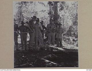 WIDE BAY, NEW BRITAIN, 1945-05-05. MAJ-GEN H.C.H. ROBERTSON, GOC 5 DIVISION (2), AND LT-COL R.J. HORLEY, COMMANDING OFFICER 16 INFANTRY BATTALION (4), CRITICISING A BREN GUN POSITION DURING AN ..
