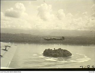 BOUGAINVILLE ISLAND, SOLOMON ISLANDS. C. 1945-01-25. A VERSATILE ANSON AIRCRAFT OF NO. 10 COMMUNICATIONS UNIT RAAF BASED AT TOROKINA SKIRTS UP THE COAST AS THE CREW WATCH FOR THE CONCEALED POSITION ..