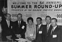 Six men and one woman stand in front of sign reading Welcome to the 8th Annual Summer Round-up! Presented by the Golden Pacific Group, San Jose KEEN/KBAY; Las Vegas KVEG; Lodi KCVR; Hawaii KAHU, inside Omar Khayyam's Restaurant, San Francisco