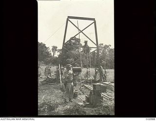 AITAPE, NORTH EAST NEW GUINEA. 1944-04-24. FLIGHT LIEUTENANT B. R. MOODY RAAF OF WAHROONGA, NSW, THE FIRST DUTY PILOT AT TADJI AIRSTRIP, MAKES READY WITH SIGNALLING LAMP TO BRING IN THE FIRST ..