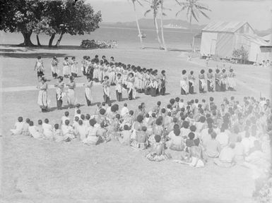 [Large crowd of Pacific Islanders  with many women possibly performing]