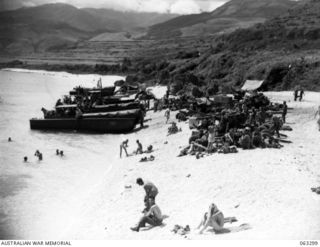 KANOMI BEACH, NEW GUINEA. 1944-01-04. TROOPS OF THE 9TH DIVISION ENJOY THE SWIMMING AND SUN BATHING WHILE AWAITING ORDERS TO MOVE FORWARD