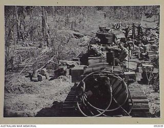 BOUGAINVILLE, 1945-05-16. A TRACTOR TOWING A MATILDA TANK OF B SQUADRON, 2/4 ARMOURED REGIMENT WHICH RECEIVED A DIRECT HIT FROM JAPANESE ARTILLERY. THIS IS THE FIRST TANK TO BE PUT OUT OF ACTION BY ..