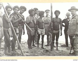 WANIGELA, NEW GUINEA. 1942-10. GENERAL SIR THOMAS BLAMEY GBE KCB CMG DSO ED, COMMANDING ALLIED LAND FORCES, SOUTH WEST PACIFIC AREA CHATTING TO NATIVES WHO WERE ON THEIR WAY TO WORK IN THEIR ..