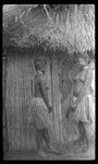 Two young women beside a house