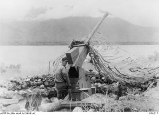 GOODENOUGH ISLAND, NEW GUINEA, 1942-10. A DUMMY ANTI AIRCRAFT GUN, PART OF A MASTERPIECE OF BLUFF AND DECEPTION PRACTISED BY A SMALL FORCE OF AUSTRALIANS WHO SEIZED THE ISLAND. THEY CONVINCED THE ..