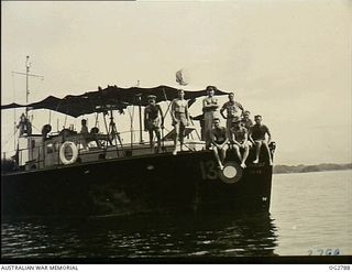 AITAPE, NORTH EAST NEW GUINEA. C. 1945. MEMBERS OF THE CREW OF THE RAAF AIR-SEA RESCUE LAUNCH SERIAL NO. 03-13 ARE NOT SUPERSTITIOUS OF NO. 13