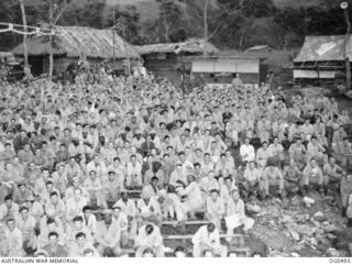 NEW GUINEA. 1944-01-08. THIS APPRECIATIVE AUDIENCE IS SEATED AT AN OUTDOOR FILM SHOWING AT A RAAF STATION. UNITED STATES NEGROES ARE ALSO IN THE AUDIENCE