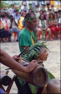 Ceremonial drummer and elderly woman (Sixth Festival of Pacific Arts?)