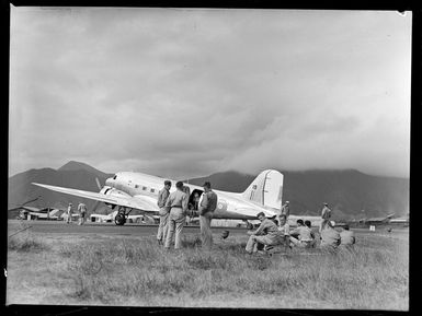 Tontouta Airfield and unidentified military personnel in front of a Dakota transport plane, New Caledonia
