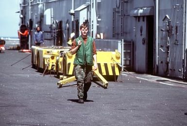 A member of Marine Medium Helicopter Squadron 264 (HMM-264) takes a break aboard the amphibious assault ship USS SAIPAN (LHA-2). The SAIPAN is taking part in exercise Ocean Venture '81