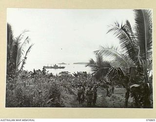 JACQUINOT BAY, NEW BRITAIN. 1944-11-07. A VIEW OF THE BAY FROM HEADQUARTERS, 6TH INFANTRY BRIGADE IN THE WUNUNG PLANTATION SHOWING THE AMERICAN TROOPSHIP, CAPE ALEXANDER IN THE DISTANCE