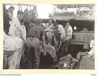 LALUM, BOUGAINVILLE, 1945-06-12. WOUNDED MEMBERS OF 31/51 INFANTRY BATTALION BEING TRANSFERRED FROM A BARGE TO HOSPITAL SHIP STRADBROKE. THEY WERE MOVED FROM 19 FIELD AMBULANCE MAIN DRESSING ..