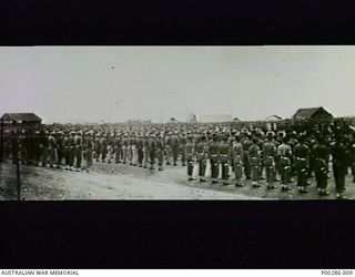 CAPE WOM AIR-STRIP, WEWAK SECTOR, NEW GUINEA, 1945-09-13. 6TH DIVISION, AIF 'PRESENTS ARMS' AT THE SURRENDER CEREMONY OF LIEUTENANT-GENERAL HATAZO ADACHI, COMMANDER OF THE JAPANESE 18TH ARMY, TO ..
