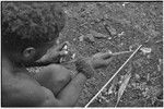 Carving: stone tool being used to smooth an arrow