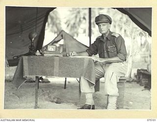 MILILAT, NEW GUINEA. 1944-08-06. QX34606 MAJOR S.F. HODGENS, THE PERMANENT PRESIDENT OF COURTS MARTIAL, HEADQUARTERS, 5TH DIVISION IN HIS TENT