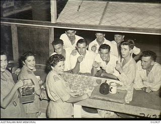 TOROKINA, BOUGAINVILLE ISLAND, SOLOMON ISLANDS. 1945-04-11. RAAF PATIENTS AT AN ARMY GENERAL HOSPITAL APPRECIATE THE SERVICE RENDERED BY RED CROSS WORKERS SUPPLYING MORNING TEA FROM A BUFFET IN THE ..