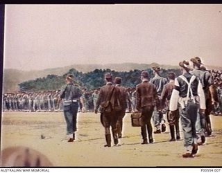 Commander of the 18th Japanese Army in New Guinea, Lieutenant General Hatazo Adachi, with his surrender party moving away from Cape Wom airstrip after having signed the surrender document marking ..