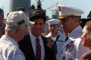 GEN Colin Powell, chairman of the Joint Chiefs of STAFF, converses with guests aboard the battleship USS MISSOURI (BB-63) during an observance commemorating the 50th anniversary of the Japanese attack on Pearl Harbor