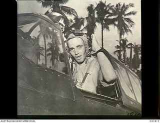 MOMOTE, LOS NEGROS ISLAND, ADMIRALTY ISLANDS. C. 1944-04. PORTRAIT OF FLIGHT SERGEANT FRANCIS H. MILES OF MELBOURNE, VIC, AND NO. 76 (KITTYHAWK) SQUADRON RAAF AS HE THROWS BACK THE "GREENHOUSE" OF ..