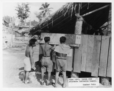 Prisoners of war viewing bulletin at ISCOM stockade