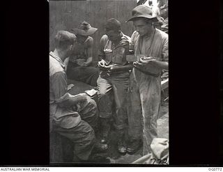 AT SEA IN THE ADMIRALTY ISLANDS AREA. 1944-03-08. RAAF AIRMEN PLAYING CARDS ON BOARD SHIP ON THEIR WAY TO THE ADMIRALTY ISLANDS. LEFT TO RIGHT: AIRCRAFTMAN 1 (AC1) T. E. DWYER, CAIRNS, QLD; AC1 M. ..