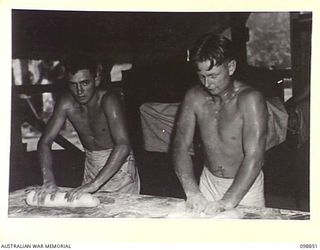 FAURO ISLAND, BOUGAINVILLE AREA. 1945-11-12. CORPORAL V. POWELL (1) AND PRIVATE G.S. CAMPBELL (2), MEMBERS OF 11 FIELD BAKERY, ATTACHED BATTALION HEADQUARTERS, 7 INFANTRY BATTALION ROLLING DOUGH ..